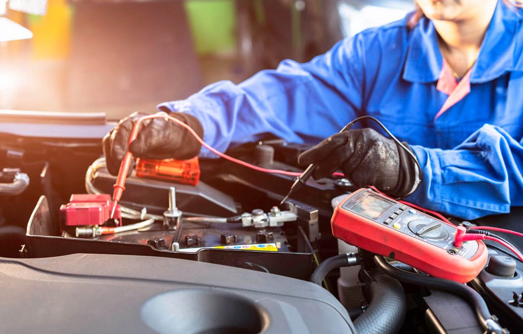 Technician testing voltage with multimeter, call us now Marco Island, FL