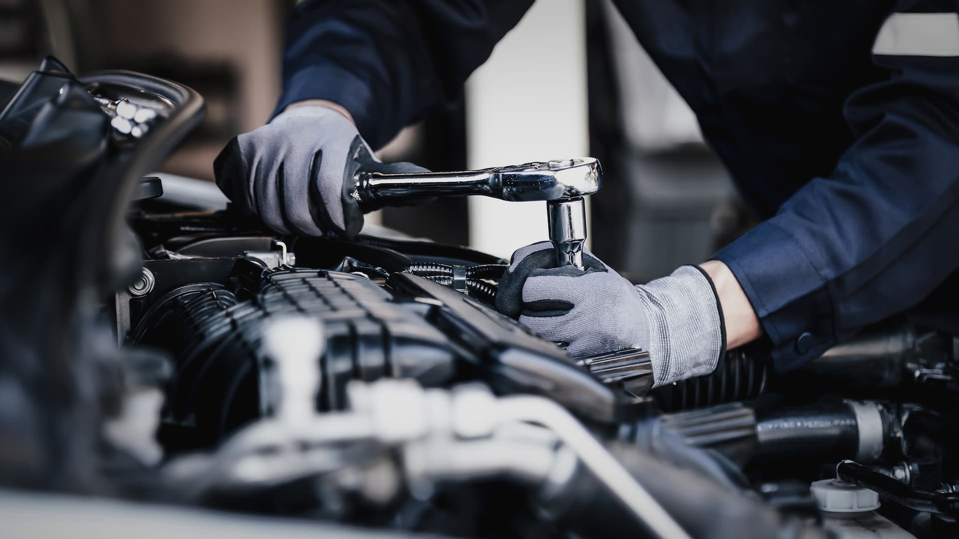 Mechanic using ratchet wrench on engine parts, engine repair Fort Myers, FL