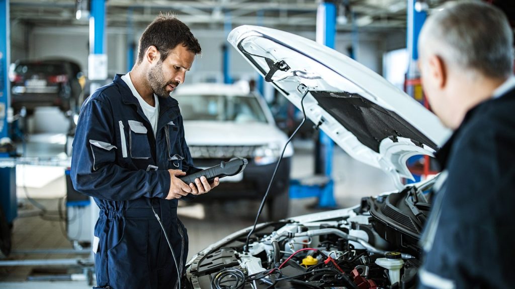 Auto mechanic reviewing diagnostics with client, call us now Marco Island, FL