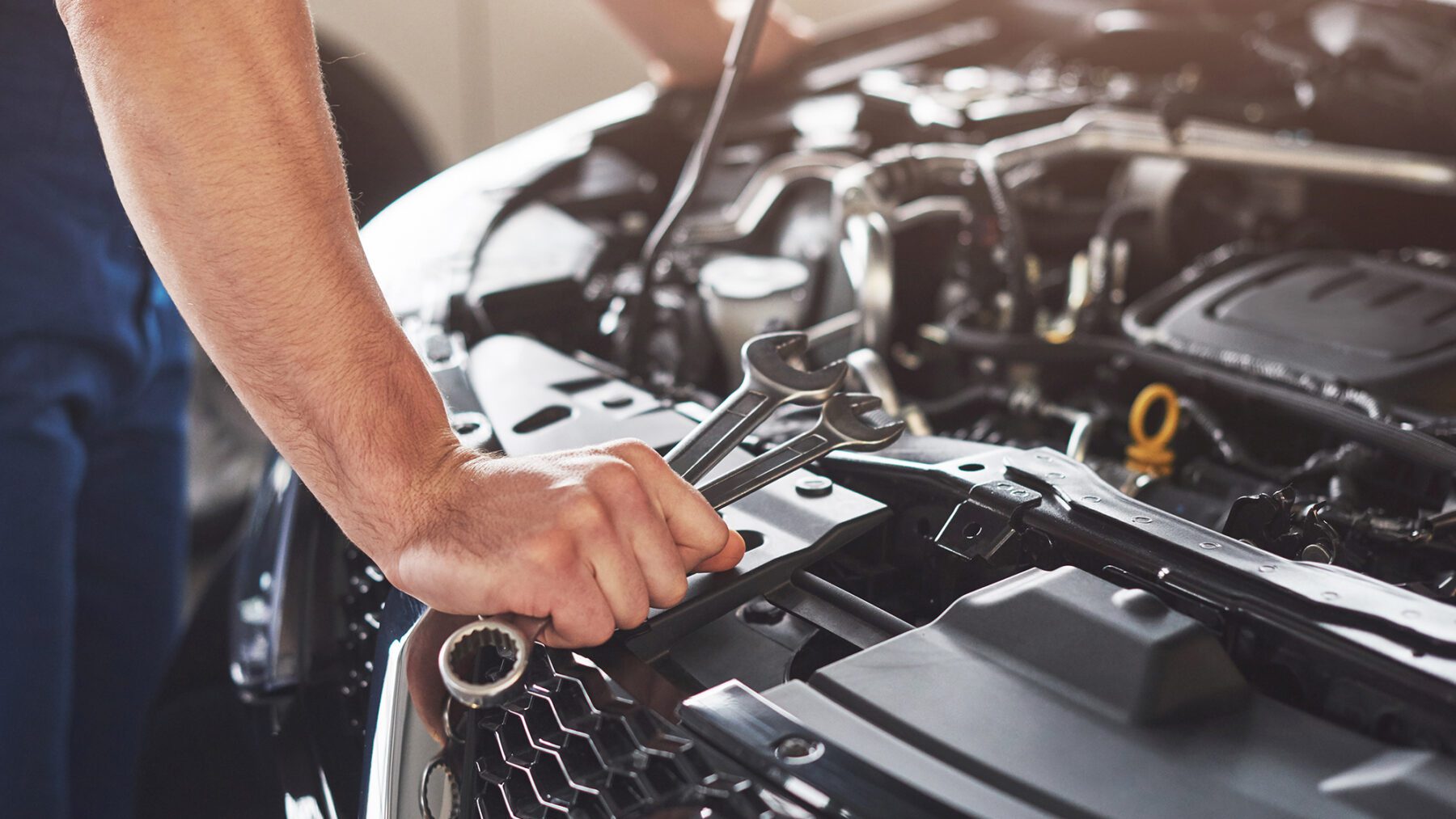 Mechanic tightening engine bolts with wrenches, engine repair Fort Myers, FL
