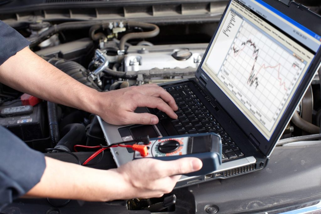 Technician analyzing diagnostic laptop data, who we are Marco Island, FL